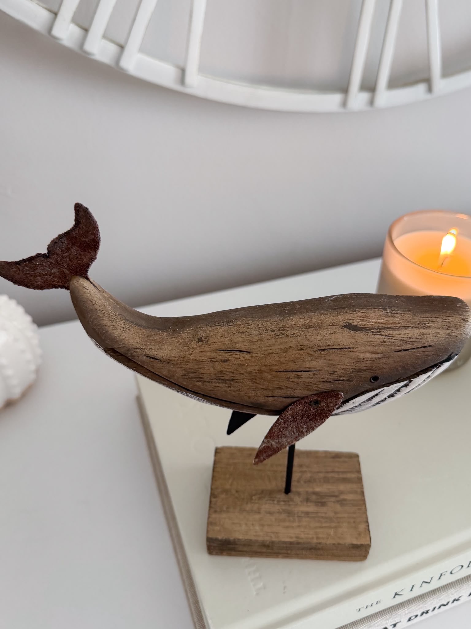 Decorative wooden whale on stand