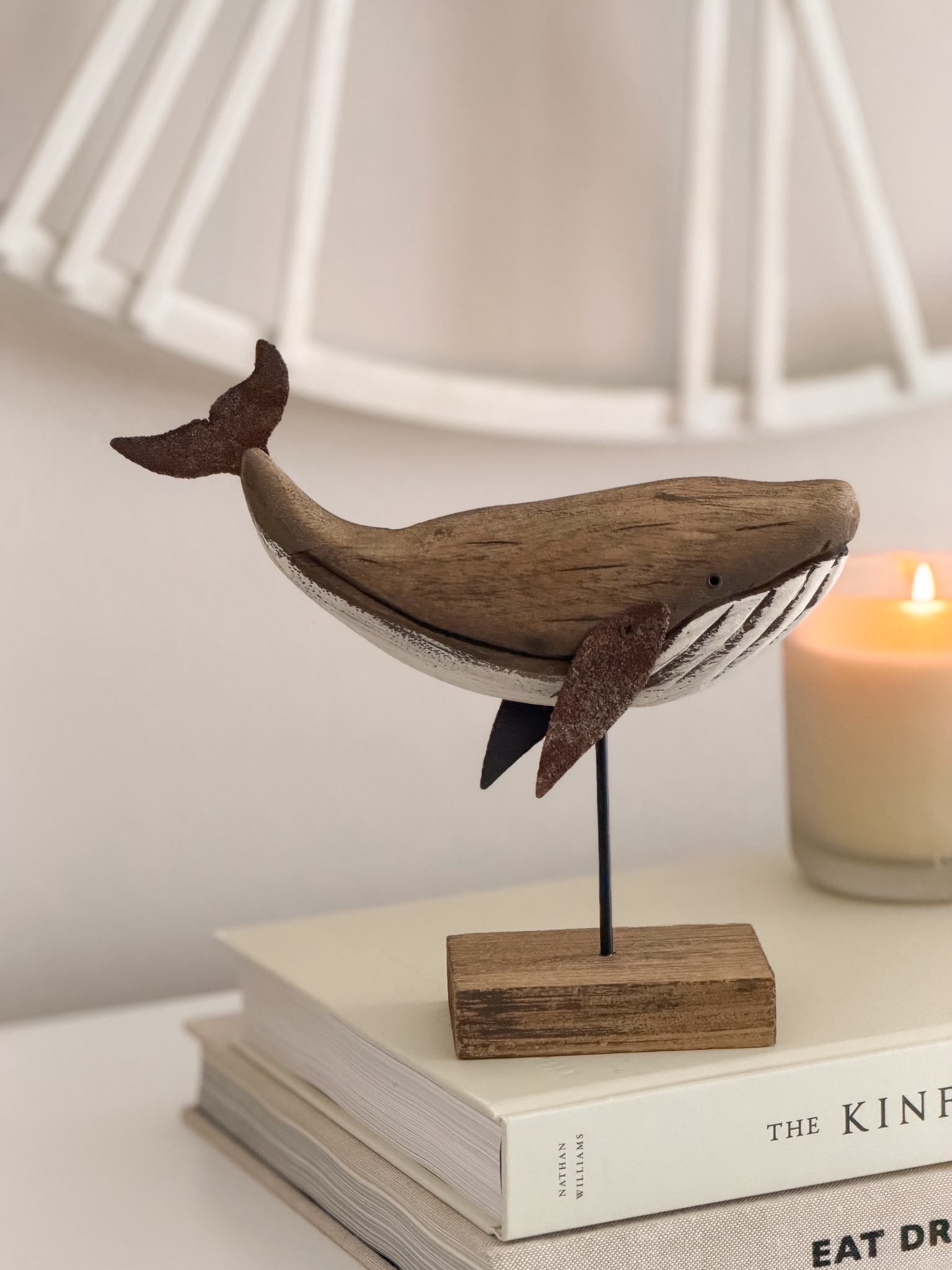 Decorative wooden whale on stand