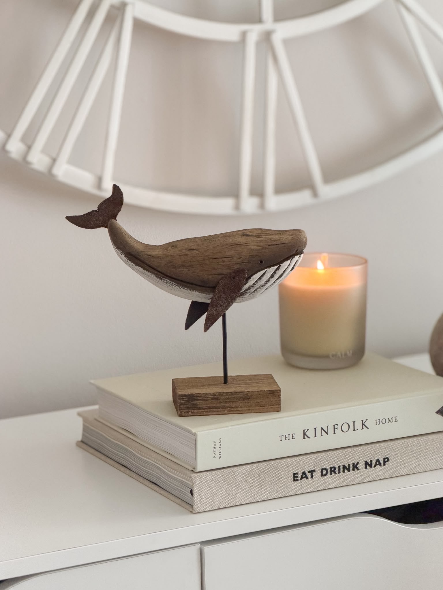 Decorative wooden whale on stand